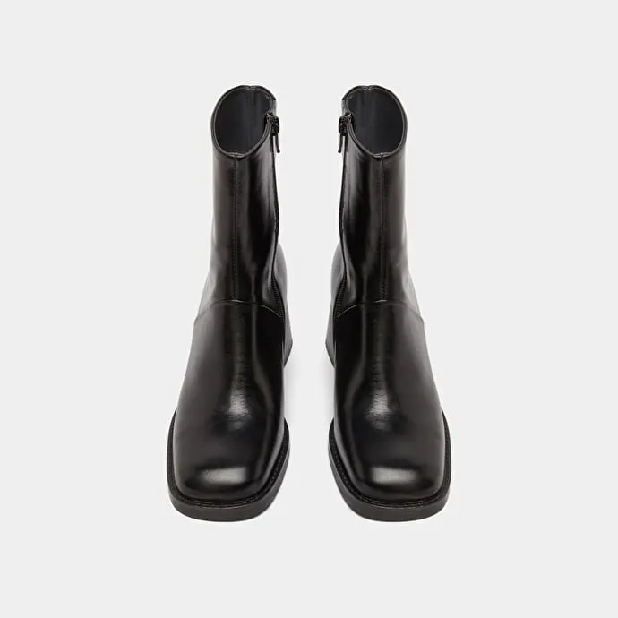 Square-toe boots with exposed seams in black leather